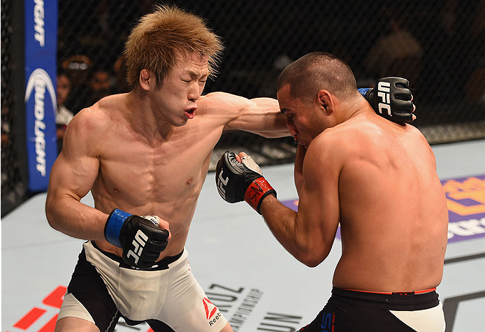 LAS VEGAS, NV - JANUARY 02: (L-R) Michinori Tanaka of Japan punches Joe Soto in their bantamweight bout during the UFC 195 event inside MGM Grand Garden Arena on January 2, 2016 in Las Vegas, Nevada. (Photo by Josh Hedges/Zuffa LLC/Zuffa LLC via Getty Im