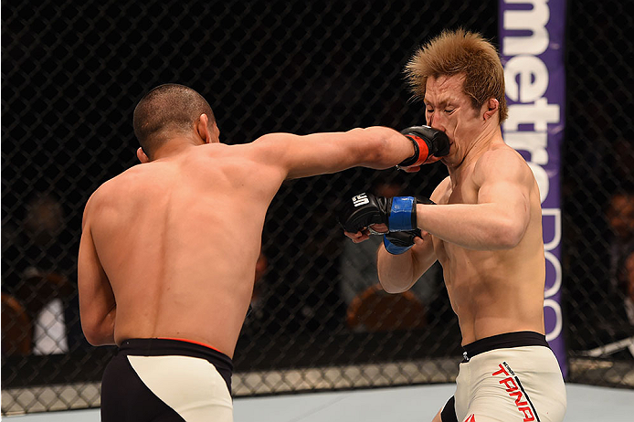 LAS VEGAS, NV - JANUARY 02: (L-R) Joe Soto punches Michinori Tanaka of Japan in their bantamweight bout during the UFC 195 event inside MGM Grand Garden Arena on January 2, 2016 in Las Vegas, Nevada. (Photo by Josh Hedges/Zuffa LLC/Zuffa LLC via Getty Im