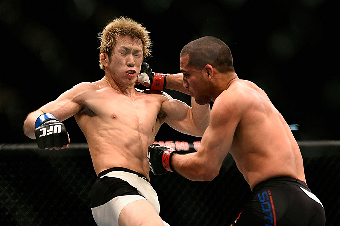 LAS VEGAS, NV - JANUARY 02: (R-L) Joe Soto punches Michinori Tanaka of Japan in their bantamweight bout during the UFC 195 event inside MGM Grand Garden Arena on January 2, 2016 in Las Vegas, Nevada. (Photo by Jeff Bottari/Zuffa LLC/Zuffa LLC via Getty I