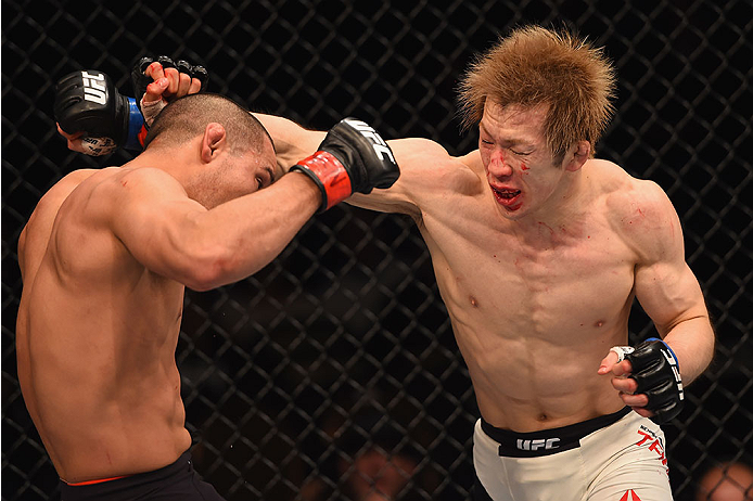 LAS VEGAS, NV - JANUARY 02: (R-L) Michinori Tanaka of Japan punches Joe Soto in their bantamweight bout during the UFC 195 event inside MGM Grand Garden Arena on January 2, 2016 in Las Vegas, Nevada. (Photo by Josh Hedges/Zuffa LLC/Zuffa LLC via Getty Im