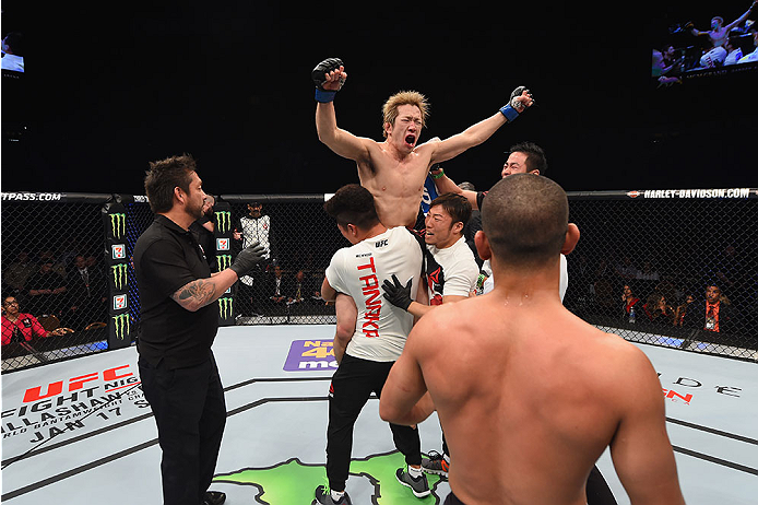 LAS VEGAS, NV - JANUARY 02: Michinori Tanaka of Japan (top) reacts to his victory over Joe Soto in their bantamweight bout during the UFC 195 event inside MGM Grand Garden Arena on January 2, 2016 in Las Vegas, Nevada. (Photo by Josh Hedges/Zuffa LLC/Zuf