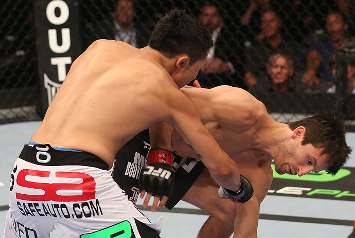 DENVER, CO - AUGUST 11: (L-R) Erik Perez knocks down Ken Stone with a punch during their bantamweight bout at UFC 150 inside Pepsi Center on August 11, 2012 in Denver, Colorado. (Photo by Nick Laham/Zuffa LLC/Zuffa LLC via Getty Images)