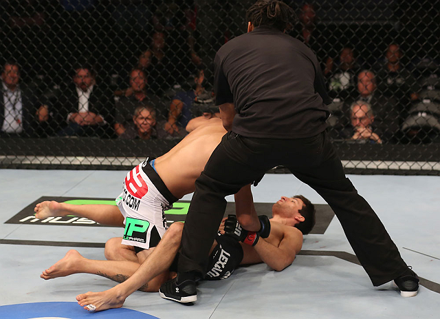 DENVER, CO - AUGUST 11: Referee Herb Dean steps in to stop the bout as Erik Perez (L) knocks out Ken Stone during their bantamweight bout at UFC 150 inside Pepsi Center on August 11, 2012 in Denver, Colorado. (Photo by Nick Laham/Zuffa LLC/Zuffa LLC via