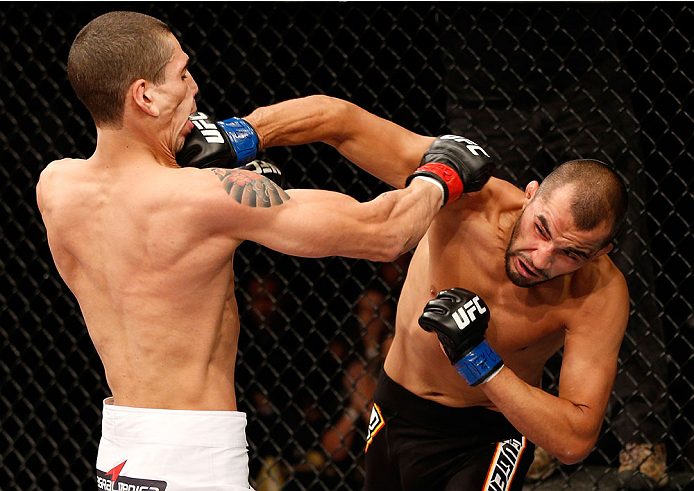 BELO HORIZONTE, BRAZIL - SEPTEMBER 04: (R-L) Junior Hernandez punches Lucas Martins in their bantamweight fight during the UFC on FOX Sports 1 event at Mineirinho Arena on September 4, 2013 in Belo Horizonte, Brazil. (Photo by Josh Hedges/Zuffa LLC/Zuffa
