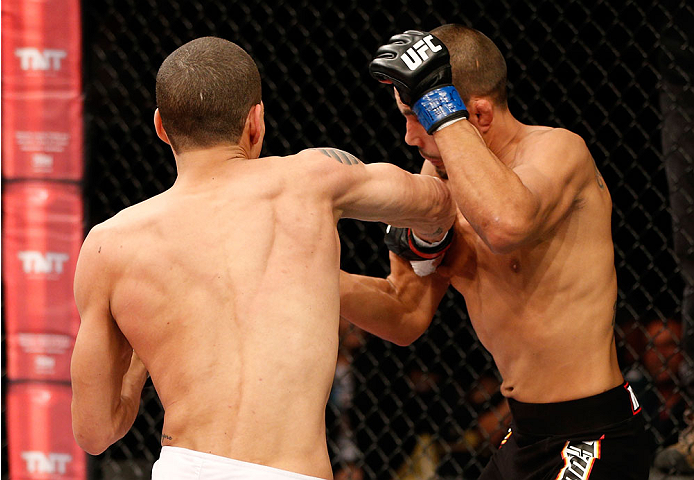 BELO HORIZONTE, BRAZIL - SEPTEMBER 04: (L-R) Lucas Martins drops Junior Hernandez with a punch in their bantamweight fight during the UFC on FOX Sports 1 event at Mineirinho Arena on September 4, 2013 in Belo Horizonte, Brazil. (Photo by Josh Hedges/Zuff