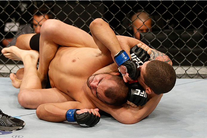 BELO HORIZONTE, BRAZIL - SEPTEMBER 04: (R-L) Lucas Martins secures a rear choke submission against Junior Hernandez in their bantamweight fight during the UFC on FOX Sports 1 event at Mineirinho Arena on September 4, 2013 in Belo Horizonte, Brazil. (Phot