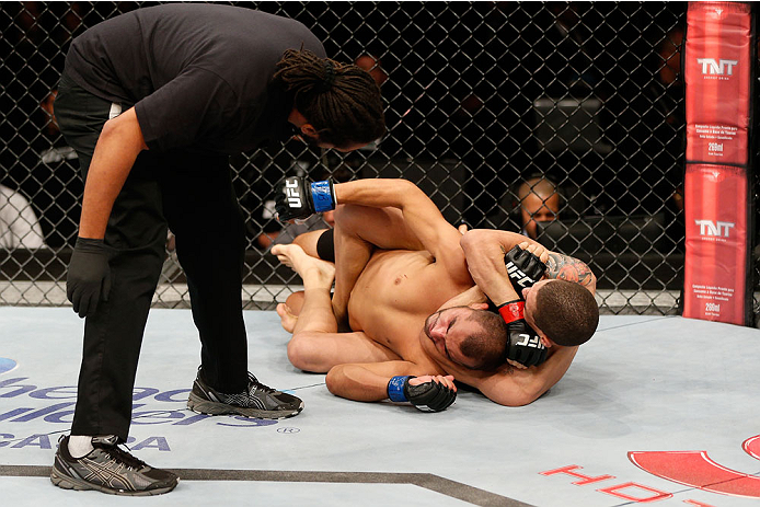 BELO HORIZONTE, BRAZIL - SEPTEMBER 04: (R-L) Lucas Martins secures a rear choke submission against Junior Hernandez in their bantamweight fight during the UFC on FOX Sports 1 event at Mineirinho Arena on September 4, 2013 in Belo Horizonte, Brazil. (Phot
