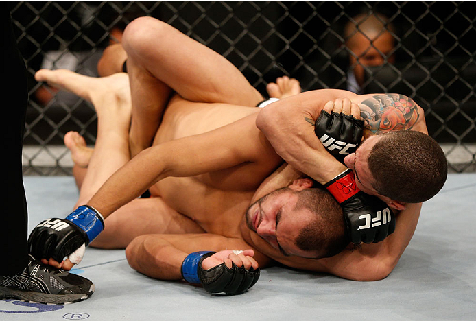 BELO HORIZONTE, BRAZIL - SEPTEMBER 04: (R-L) Lucas Martins secures a rear choke submission against Junior Hernandez in their bantamweight fight during the UFC on FOX Sports 1 event at Mineirinho Arena on September 4, 2013 in Belo Horizonte, Brazil. (Phot