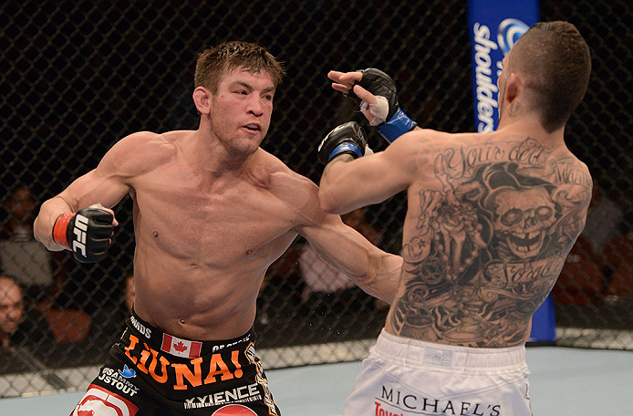 ANAHEIM, CA - FEBRUARY 23: (L-R) Sam Stout punches Caros Fodor in their lightweight bout during UFC 157 at Honda Center on February 23, 2013 in Anaheim, California. (Photo by Donald Miralle/Zuffa LLC/Zuffa LLC via Getty Images) *** Local Caption *** Sam