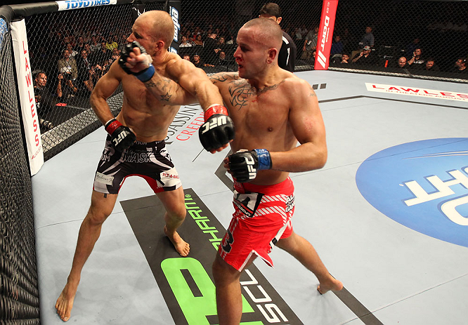 DENVER, CO - AUGUST 11: (R-L) Michael Kuiper knocks out Jared Hamman with a punch during their middleweight bout at UFC 150 inside Pepsi Center on August 11, 2012 in Denver, Colorado. (Photo by Nick Laham/Zuffa LLC/Zuffa LLC via Getty Images)