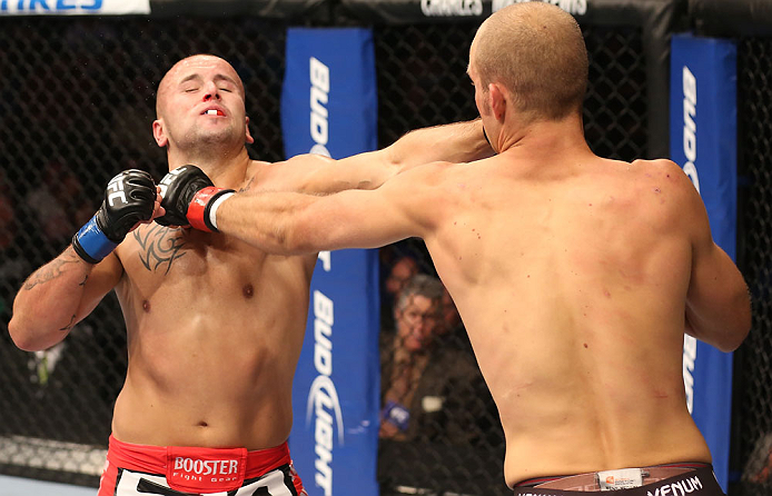 DENVER, CO - AUGUST 11: (R-L) Jared Hamman punches Michael Kuiper during their middleweight bout at UFC 150 inside Pepsi Center on August 11, 2012 in Denver, Colorado. (Photo by Nick Laham/Zuffa LLC/Zuffa LLC via Getty Images)