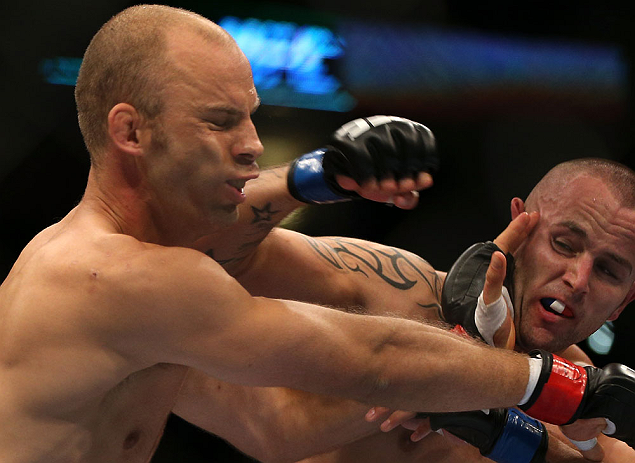 DENVER, CO - AUGUST 11: (R-L) Michael Kuiper punches Jared Hamman during their middleweight bout at UFC 150 inside Pepsi Center on August 11, 2012 in Denver, Colorado. (Photo by Josh Hedges/Zuffa LLC/Zuffa LLC via Getty Images)