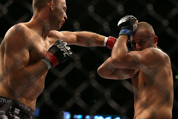DENVER, CO - AUGUST 11: (L-R) Jared Hamman punches Michael Kuiper during their middleweight bout at UFC 150 inside Pepsi Center on August 11, 2012 in Denver, Colorado. (Photo by Josh Hedges/Zuffa LLC/Zuffa LLC via Getty Images)