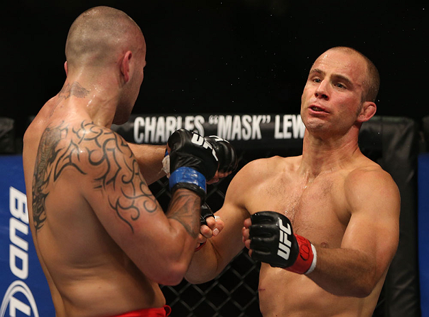 DENVER, CO - AUGUST 11: (L-R) Michael Kuiper knocks down Jared Hamman with a punch during their middleweight bout at UFC 150 inside Pepsi Center on August 11, 2012 in Denver, Colorado. (Photo by Josh Hedges/Zuffa LLC/Zuffa LLC via Getty Images)