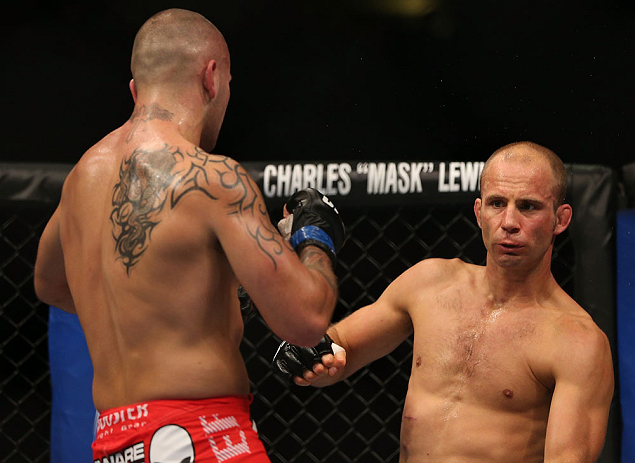 DENVER, CO - AUGUST 11: (L-R) Michael Kuiper knocks down Jared Hamman with a punch during their middleweight bout at UFC 150 inside Pepsi Center on August 11, 2012 in Denver, Colorado. (Photo by Josh Hedges/Zuffa LLC/Zuffa LLC via Getty Images)