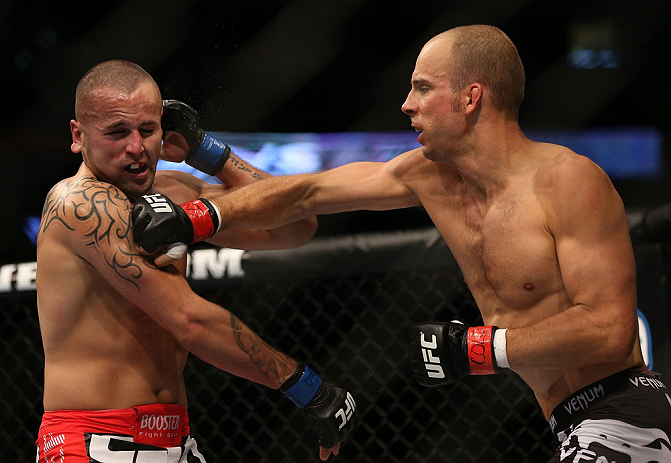 DENVER, CO - AUGUST 11: (R-L) Jared Hamman punches Michael Kuiper during their middleweight bout at UFC 150 inside Pepsi Center on August 11, 2012 in Denver, Colorado. (Photo by Josh Hedges/Zuffa LLC/Zuffa LLC via Getty Images)