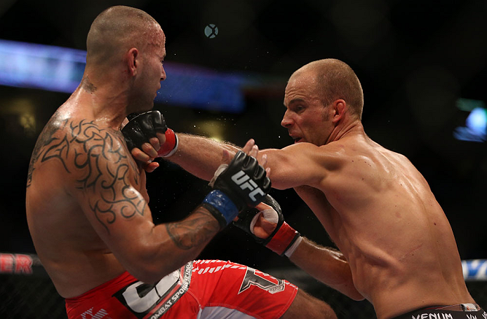 DENVER, CO - AUGUST 11: (R-L) Jared Hamman punches Michael Kuiper during their middleweight bout at UFC 150 inside Pepsi Center on August 11, 2012 in Denver, Colorado. (Photo by Josh Hedges/Zuffa LLC/Zuffa LLC via Getty Images)