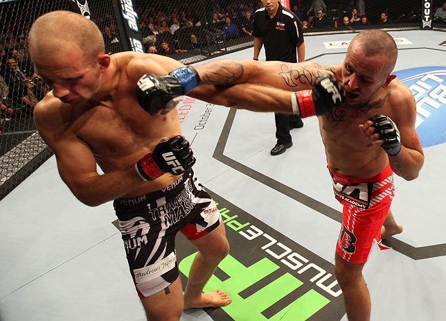 DENVER, CO - AUGUST 11: (R-L) Michael Kuiper punches Jared Hamman during their middleweight bout at UFC 150 inside Pepsi Center on August 11, 2012 in Denver, Colorado. (Photo by Nick Laham/Zuffa LLC/Zuffa LLC via Getty Images)