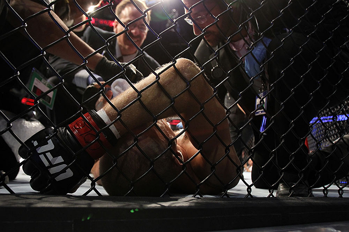 DENVER, CO - AUGUST 11: Jared Hamman lies on the canvas after being knocked out by Michael Kuiper during their middleweight bout at UFC 150 inside Pepsi Center on August 11, 2012 in Denver, Colorado. (Photo by Josh Hedges/Zuffa LLC/Zuffa LLC via Getty Im