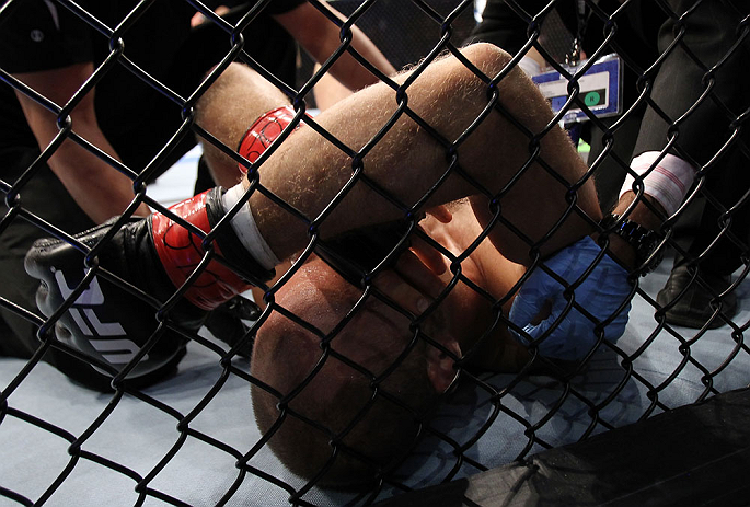 DENVER, CO - AUGUST 11: Jared Hamman lies on the canvas after being knocked out by Michael Kuiper during their middleweight bout at UFC 150 inside Pepsi Center on August 11, 2012 in Denver, Colorado. (Photo by Josh Hedges/Zuffa LLC/Zuffa LLC via Getty Im