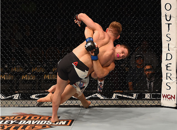 LAS VEGAS, NV - JANUARY 02: Drew Dober (back) attempts to take down Scott Holtzman (black trunks) in their lightweight bout during the UFC 195 event inside MGM Grand Garden Arena on January 2, 2016 in Las Vegas, Nevada. (Photo by Josh Hedges/Zuffa LLC/Zu