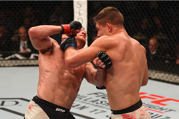 LAS VEGAS, NV - JANUARY 02: (R-L) Drew Dober punches Scott Holtzman in their lightweight bout during the UFC 195 event inside MGM Grand Garden Arena on January 2, 2016 in Las Vegas, Nevada. (Photo by Josh Hedges/Zuffa LLC/Zuffa LLC via Getty Images)