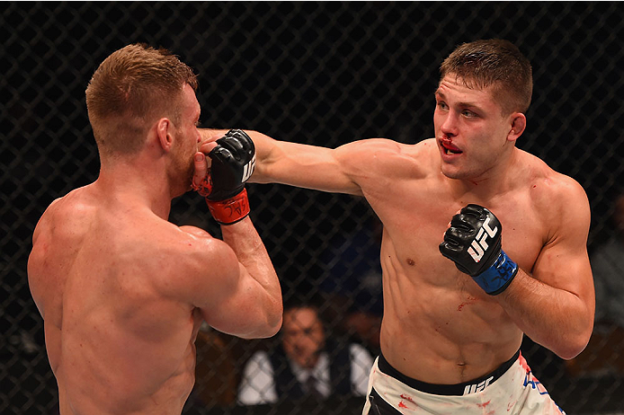 LAS VEGAS, NV - JANUARY 02: (R-L) Drew Dober punches Scott Holtzman in their lightweight bout during the UFC 195 event inside MGM Grand Garden Arena on January 2, 2016 in Las Vegas, Nevada. (Photo by Josh Hedges/Zuffa LLC/Zuffa LLC via Getty Images)