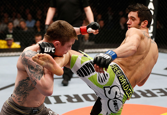 LONDON, ENGLAND - FEBRUARY 16: (R-L) Josh Grispi kicks Andy Ogle in their featherweight fight during the UFC on Fuel TV event on February 16, 2013 at Wembley Arena in London, England. (Photo by Josh Hedges/Zuffa LLC/Zuffa LLC via Getty Images)