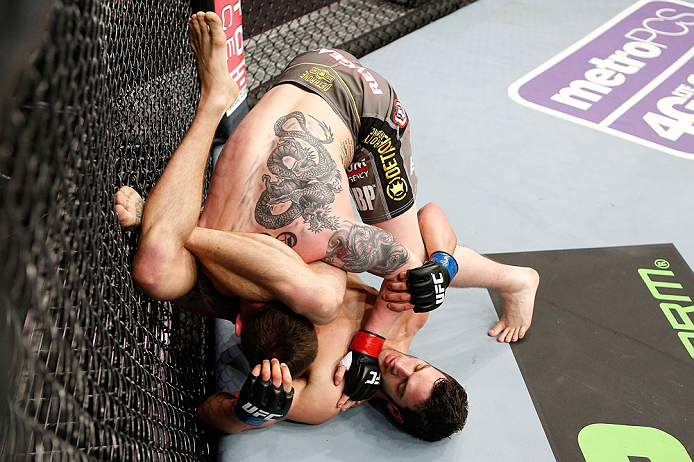 LONDON, ENGLAND - FEBRUARY 16: (R-L) Josh Grispi attempts a triangle choke against Andy Ogle in their featherweight fight during the UFC on Fuel TV event on February 16, 2013 at Wembley Arena in London, England. (Photo by Josh Hedges/Zuffa LLC/Zuffa LLC