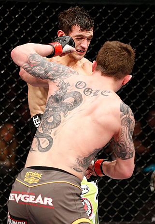 LONDON, ENGLAND - FEBRUARY 16: (R-L) Andy Ogle punches Josh Grispi in their featherweight fight during the UFC on Fuel TV event on February 16, 2013 at Wembley Arena in London, England. (Photo by Josh Hedges/Zuffa LLC/Zuffa LLC via Getty Images)