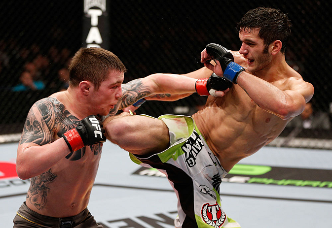 LONDON, ENGLAND - FEBRUARY 16: (L-R) Andy Ogle and Josh Grispi trade strikes in their featherweight fight during the UFC on Fuel TV event on February 16, 2013 at Wembley Arena in London, England. (Photo by Josh Hedges/Zuffa LLC/Zuffa LLC via Getty Image