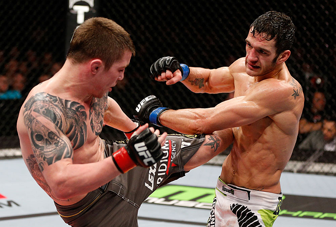 LONDON, ENGLAND - FEBRUARY 16: (L-R) Andy Ogle kicks Josh Grispi in their featherweight fight during the UFC on Fuel TV event on February 16, 2013 at Wembley Arena in London, England. (Photo by Josh Hedges/Zuffa LLC/Zuffa LLC via Getty Images)