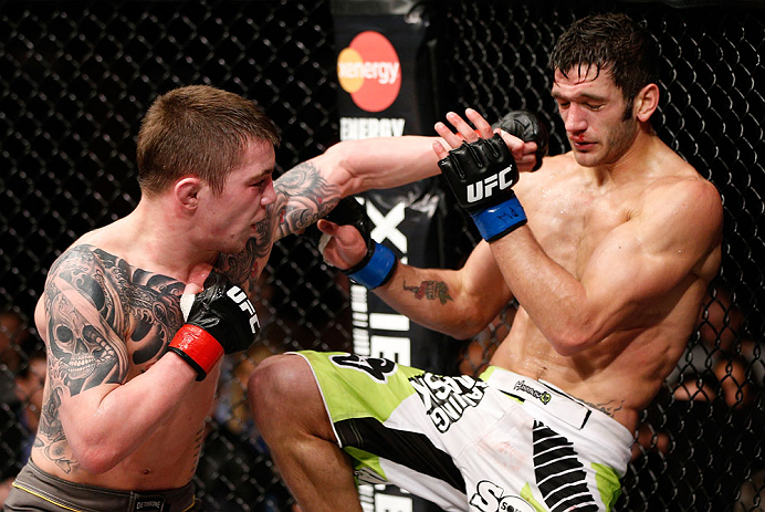 LONDON, ENGLAND - FEBRUARY 16: (L-R) Andy Ogle punches Josh Grispi in their featherweight fight during the UFC on Fuel TV event on February 16, 2013 at Wembley Arena in London, England. (Photo by Josh Hedges/Zuffa LLC/Zuffa LLC via Getty Images)