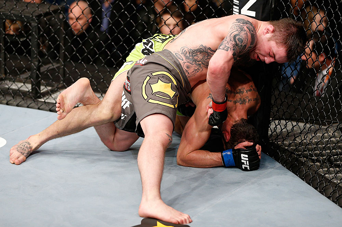 LONDON, ENGLAND - FEBRUARY 16: (L-R) Andy Ogle punches Josh Grispi in their featherweight fight during the UFC on Fuel TV event on February 16, 2013 at Wembley Arena in London, England. (Photo by Josh Hedges/Zuffa LLC/Zuffa LLC via Getty Images)