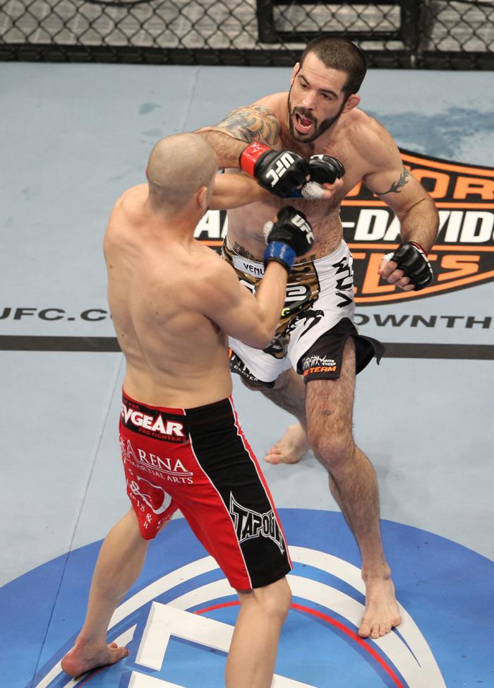 LAS VEGAS, NV - FEBRUARY 04: Matt Brown (white shorts) and Chris Cope (red/black shorts) exchange punches during the UFC 143 event at Mandalay Bay Events Center on February 4, 2012 in Las Vegas, Nevada. (Photo by Josh Hedges/Zuffa LLC/Zuffa LLC via Gett