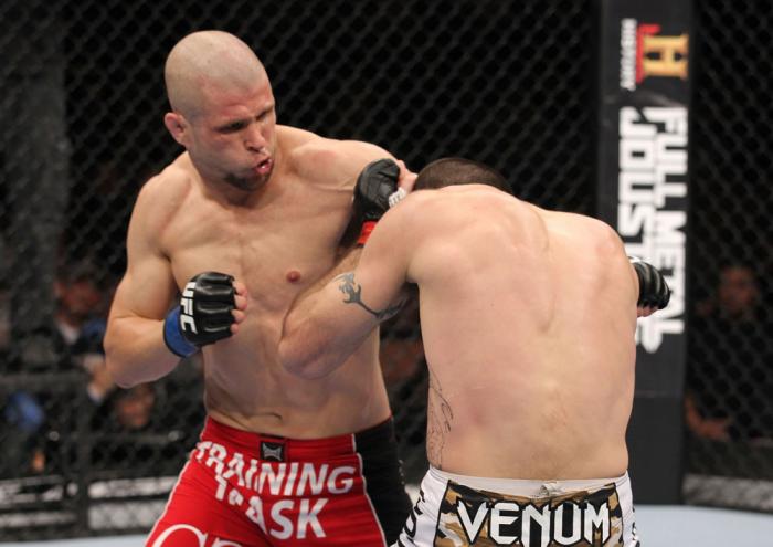 LAS VEGAS, NV - FEBRUARY 04: Chris Cope (red shorts) punches Matt Brown during the UFC 143 event at Mandalay Bay Events Center on February 4, 2012 in Las Vegas, Nevada. (Photo by Nick Laham/Zuffa LLC/Zuffa LLC via Getty Images) *** Local Caption *** Chr