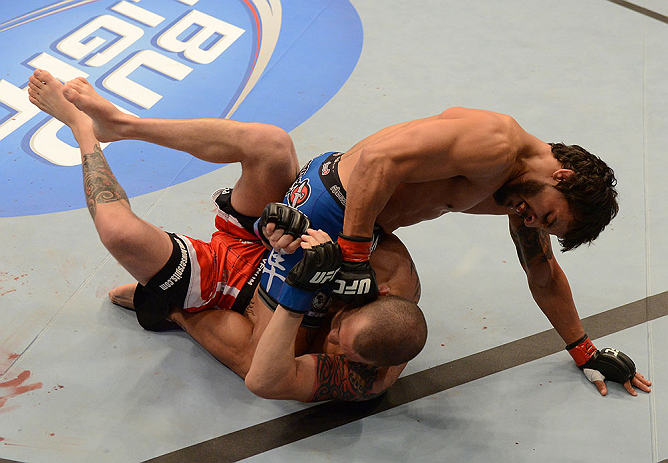 ANAHEIM, CA - FEBRUARY 23: Dennis Bermudez (top) punches Matt Grice in their featherweight bout during UFC 157 at Honda Center on February 23, 2013 in Anaheim, California. (Photo by Donald Miralle/Zuffa LLC/Zuffa LLC via Getty Images) *** Local Caption