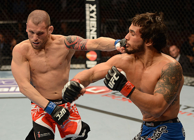 ANAHEIM, CA - FEBRUARY 23: (R-L) Dennis Bermudez punches Matt Grice in their featherweight bout during UFC 157 at Honda Center on February 23, 2013 in Anaheim, California. (Photo by Donald Miralle/Zuffa LLC/Zuffa LLC via Getty Images) *** Local Caption