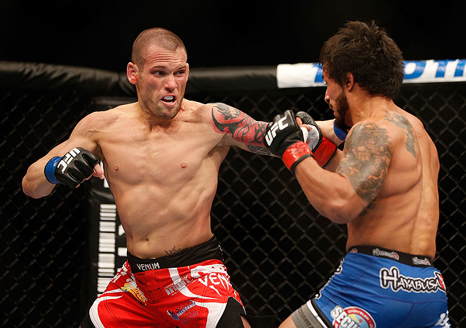 ANAHEIM, CA - FEBRUARY 23: (L-R) Matt Grice punches Dennis Bermudez in their featherweight bout during UFC 157 at Honda Center on February 23, 2013 in Anaheim, California. (Photo by Josh Hedges/Zuffa LLC/Zuffa LLC via Getty Images) *** Local Caption ***