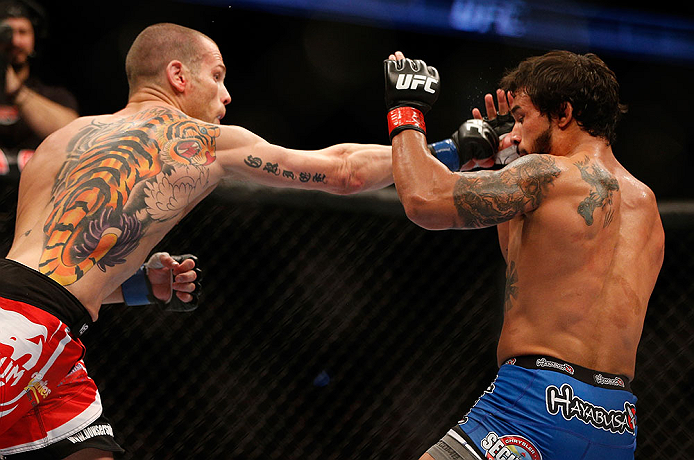 ANAHEIM, CA - FEBRUARY 23: Matt Grice (left) punches Dennis Bermudez in their featherweight bout during UFC 157 at Honda Center on February 23, 2013 in Anaheim, California. (Photo by Josh Hedges/Zuffa LLC/Zuffa LLC via Getty Images) *** Local Caption **