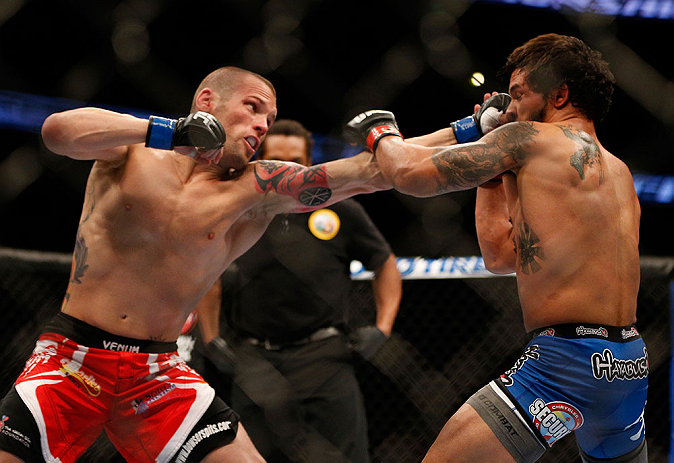 ANAHEIM, CA - FEBRUARY 23: Matt Grice (left) punches Dennis Bermudez in their featherweight bout during UFC 157 at Honda Center on February 23, 2013 in Anaheim, California. (Photo by Josh Hedges/Zuffa LLC/Zuffa LLC via Getty Images) *** Local Caption **