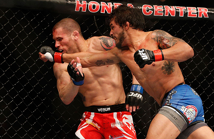 ANAHEIM, CA - FEBRUARY 23: (R-L) Dennis Bermudez (right) punches Matt Grice in their featherweight bout during UFC 157 at Honda Center on February 23, 2013 in Anaheim, California. (Photo by Josh Hedges/Zuffa LLC/Zuffa LLC via Getty Images) *** Local Cap