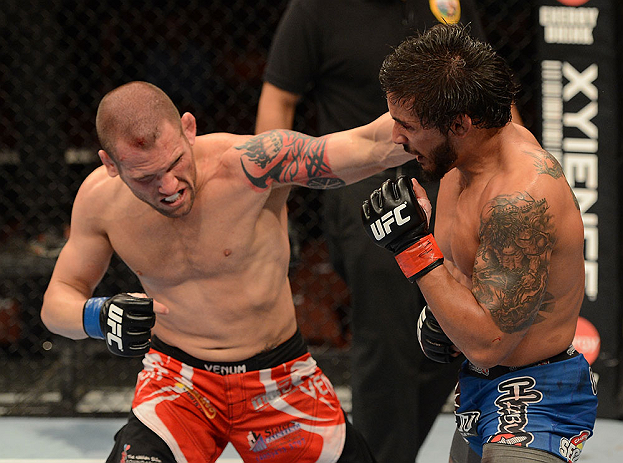 ANAHEIM, CA - FEBRUARY 23: (L-R) Matt Grice punches Dennis Bermudez in their featherweight bout during UFC 157 at Honda Center on February 23, 2013 in Anaheim, California. (Photo by Donald Miralle/Zuffa LLC/Zuffa LLC via Getty Images) *** Local Caption