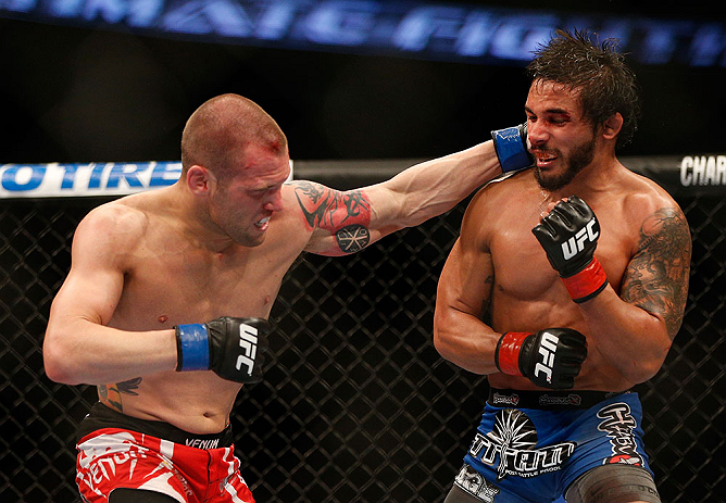 ANAHEIM, CA - FEBRUARY 23: (L-R) Matt Grice punches Dennis Bermudez in their featherweight bout during UFC 157 at Honda Center on February 23, 2013 in Anaheim, California. (Photo by Josh Hedges/Zuffa LLC/Zuffa LLC via Getty Images) *** Local Caption ***