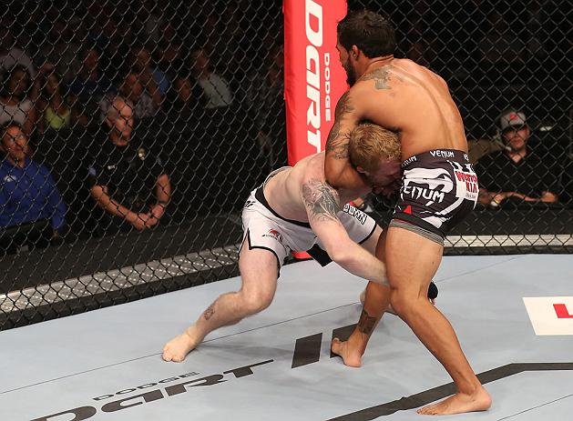 DENVER, CO - AUGUST 11: (L-R) Dennis Bermudez secures a guillotine choke against Tom Hayden during their featherweight bout at UFC 150 inside Pepsi Center on August 11, 2012 in Denver, Colorado. (Photo by Nick Laham/Zuffa LLC/Zuffa LLC via Getty Images)
