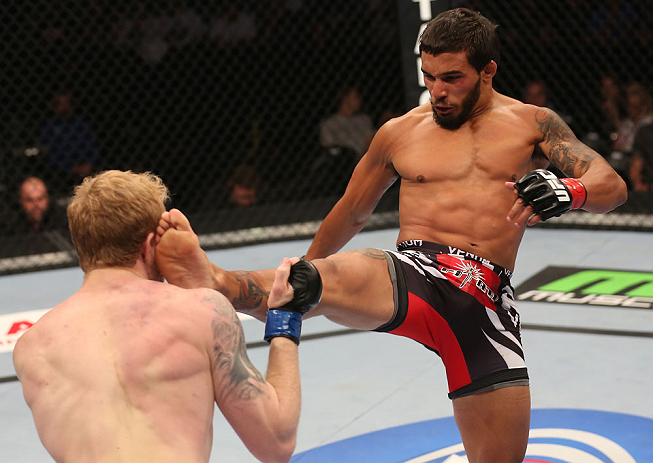 DENVER, CO - AUGUST 11: (R-L) Dennis Bermudez kicks Tommy Hayden during their featherweight bout at UFC 150 inside Pepsi Center on August 11, 2012 in Denver, Colorado. (Photo by Nick Laham/Zuffa LLC/Zuffa LLC via Getty Images)
