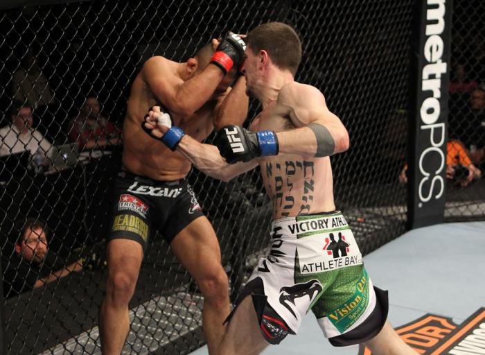 OMAHA, NE - FEBRUARY 15: (R-L) John Albert punches Ivan Menjivar during the UFC on FUEL TV event at Omaha Civic Auditorium on February 15, 2012 in Omaha, Nebraska. (Photo by Josh Hedges/Zuffa LLC/Zuffa LLC via Getty Images) *** Local Caption *** Ivan Me