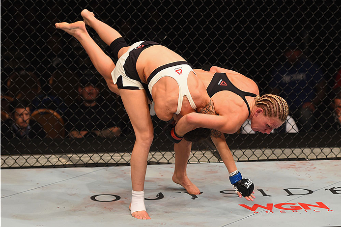 LAS VEGAS, NV - JANUARY 02: Justine Kish (black) takes down Nina Ansaroff (white) in their women's strawweight bout during the UFC 195 event inside MGM Grand Garden Arena on January 2, 2016 in Las Vegas, Nevada. (Photo by Josh Hedges/Zuffa LLC/Zuffa LLC