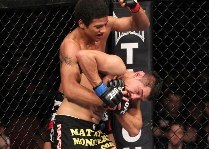 LAS VEGAS, NV - FEBRUARY 04: Alex Caceres (top) delivers punches to Edwin Figueora during the UFC 143 event at Mandalay Bay Events Center on February 4, 2012 in Las Vegas, Nevada. (Photo by Nick Laham/Zuffa LLC/Zuffa LLC via Getty Images) *** Local Capt