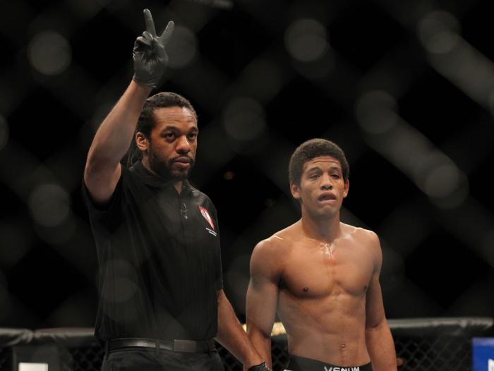 LAS VEGAS, NV - FEBRUARY 04: Referee Herb Dean (left) deducts two points from Alex Caceres after a series of low blows in his fight against Edwin Figueroa during the UFC 143 event at Mandalay Bay Events Center on February 4, 2012 in Las Vegas, Nevada. (